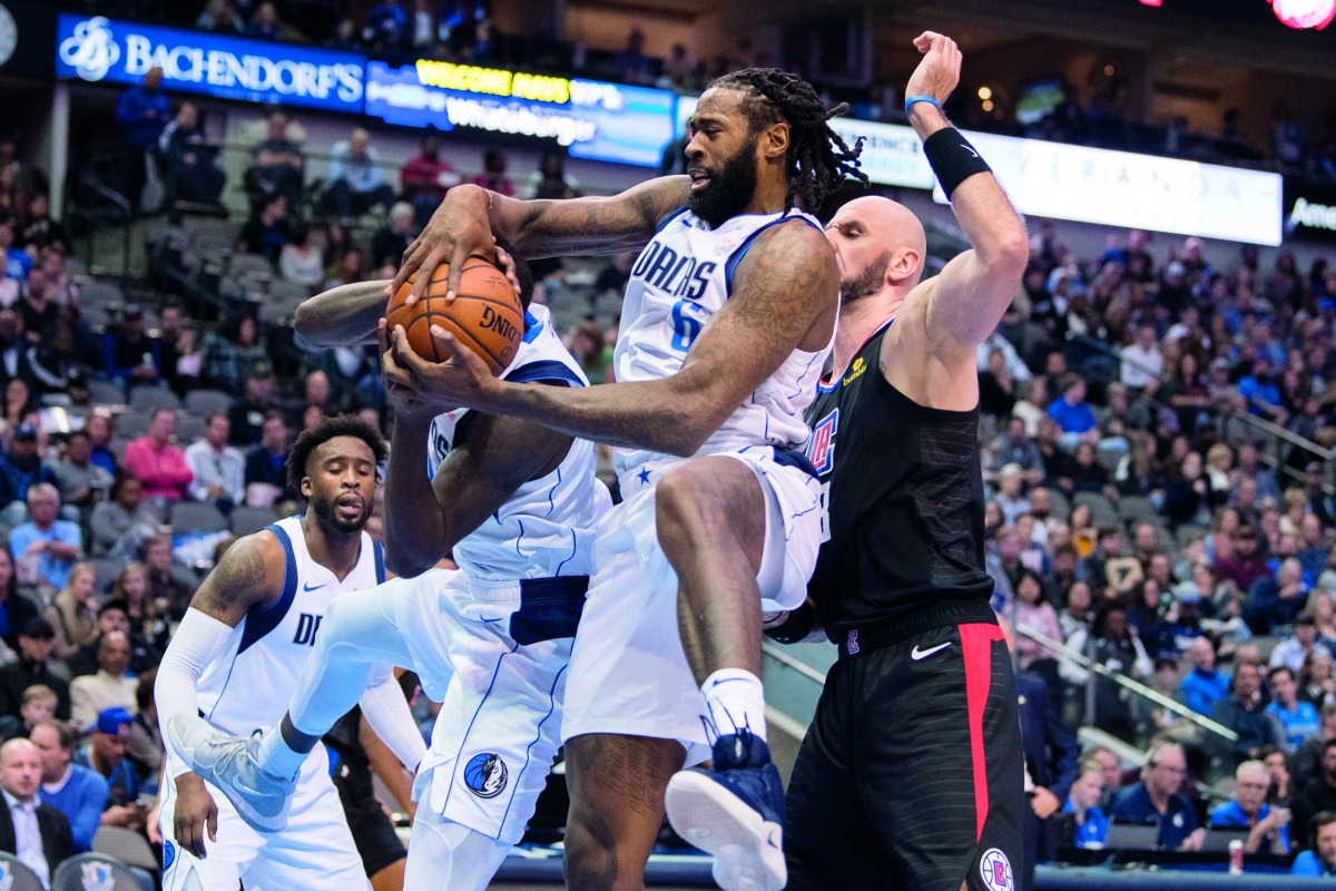 Dallas Mavericks center DeAndre Jordan (6) grabs a rebound in front of LA Clippers center Marcin Gortat (13) during the second half at the American Airlines Center. Credit: Jerome Miron/USA Today Sports 
