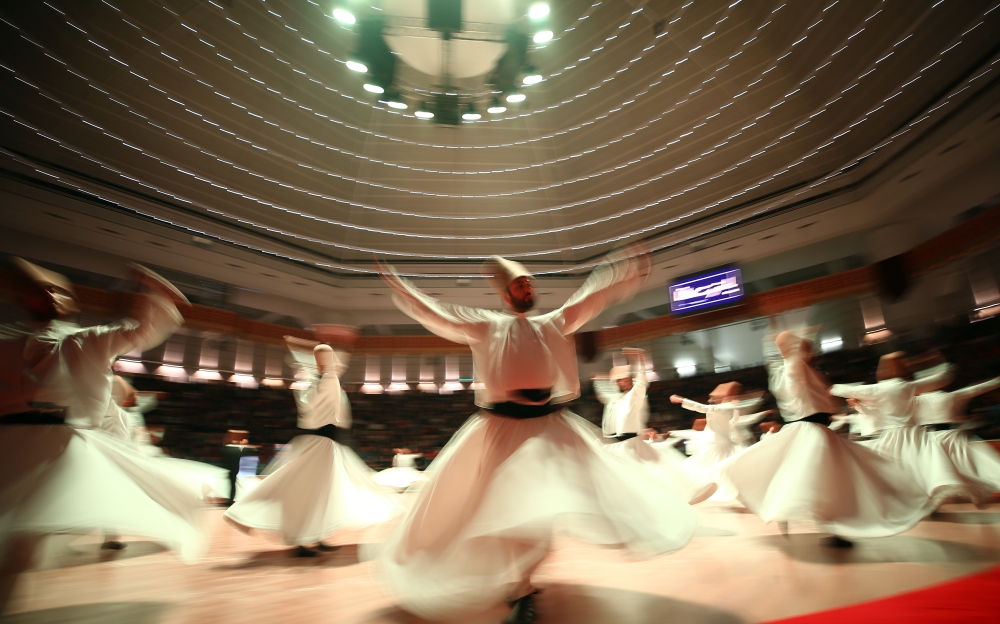 Members of Konya Turkish Sufi Music Ensemble perform Sema ceremony during an event to commemorate 745th death anniversary of Mevlana Jalaluddin al-Rumi, in Konya, Turkey on December 16, 2018 (Abdullah Co?kun/Anadolu Agency)