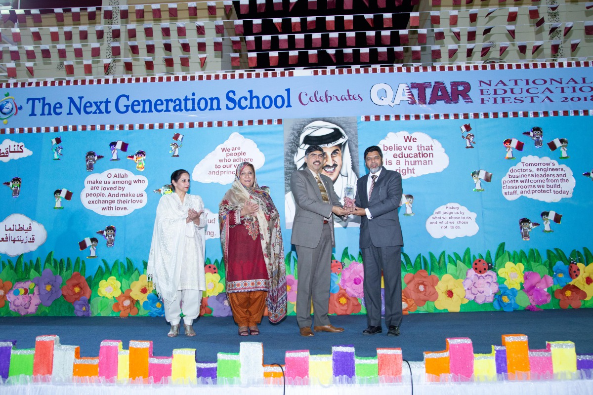 Commodore Irfan Taj, Defence Attache of Pakistan Embassy, receives a memento from Riyaz Bakali   during the Qatar National Day Educational Fiesta 2018 at TNG. 