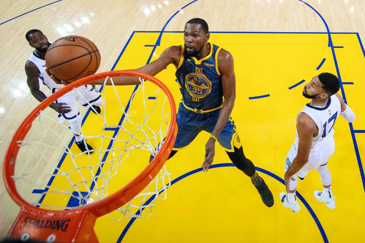 Golden State Warriors forward Kevin Durant (35) shoots the basketball against Memphis Grizzlies guard Garrett Temple (17) and forward Jaren Jackson Jr. (13) during the first half at Oracle Arena. Credit: Kyle Terada-USA TODAY Sports 