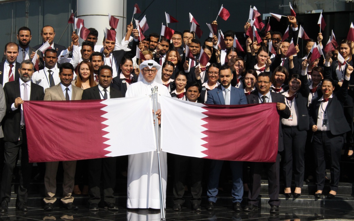 Regency Travel & Tours officials and employees pose for a group photo during Qatar National Day celebrations.  