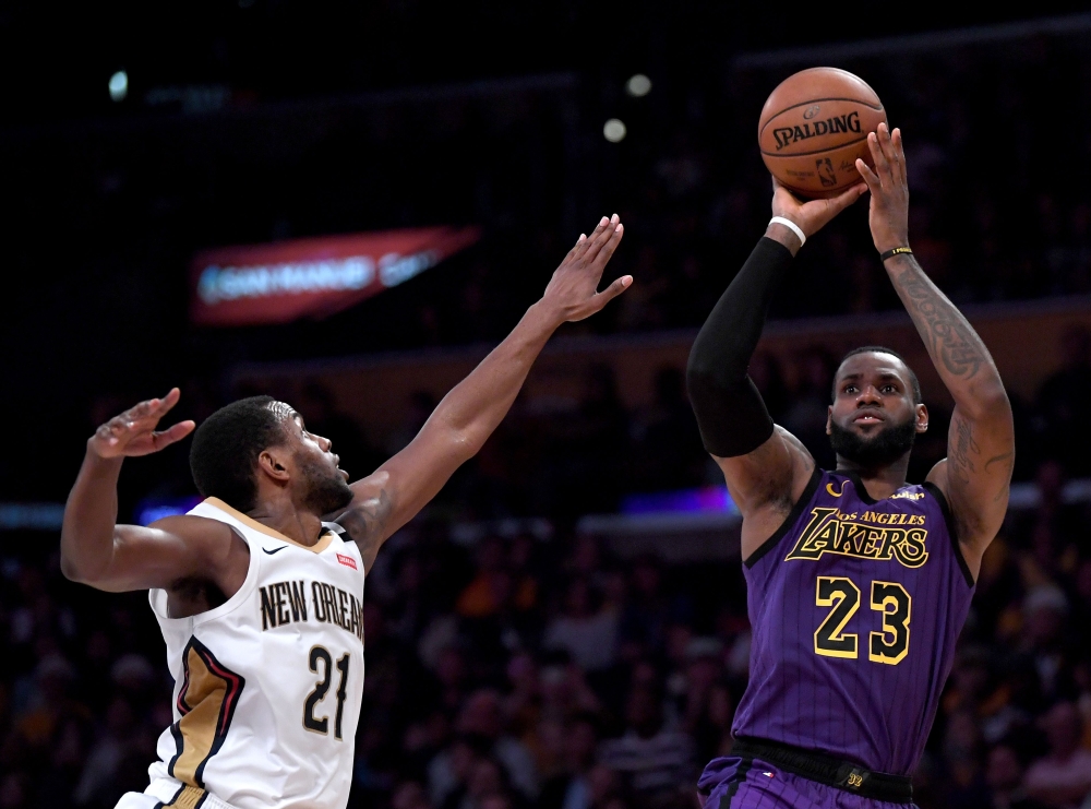 LeBron James #23 of the Los Angeles Lakers scores on a fadeaway jumper over Darius Miller #21 of the New Orleans Pelicans during a 112-104 Laker win at Staples Center on December 21, 2018 in Los Angeles, California. Harry How/AFP