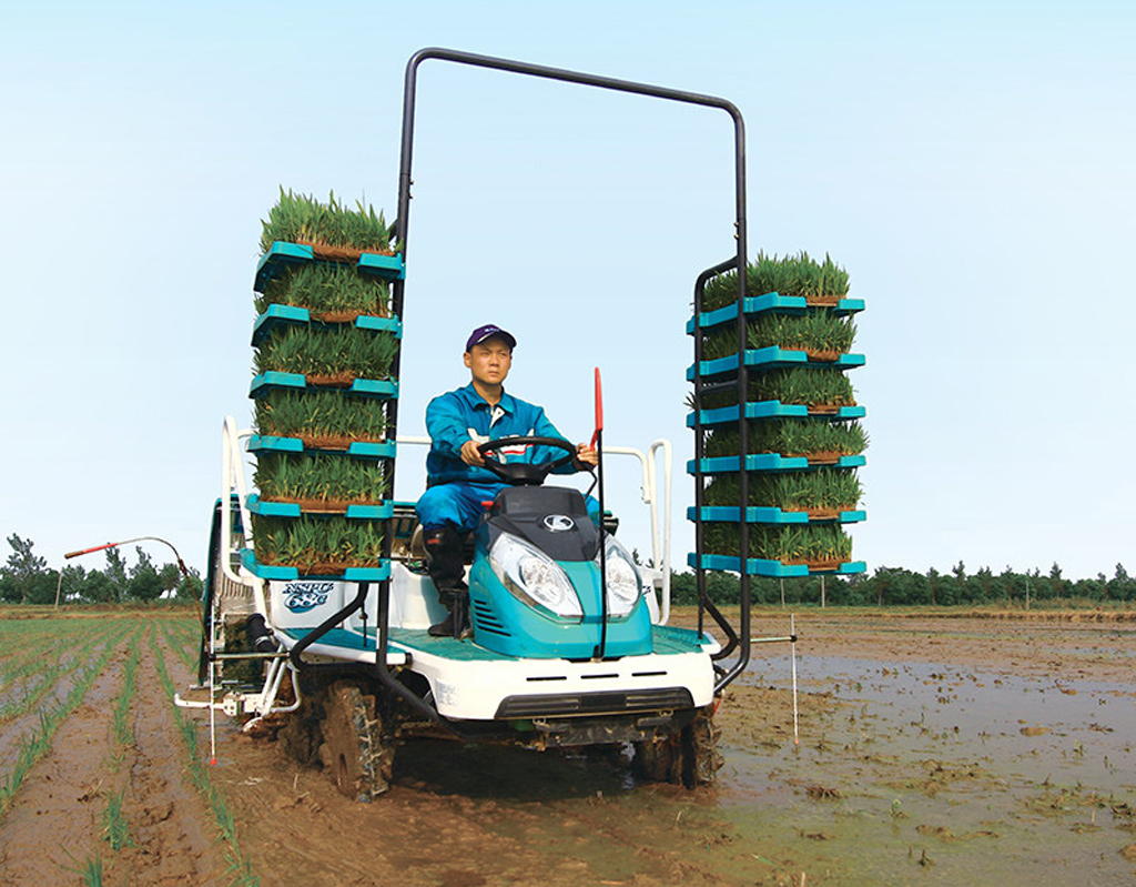 Image of a combined harvester and rice transplanter. Kubota Corp.