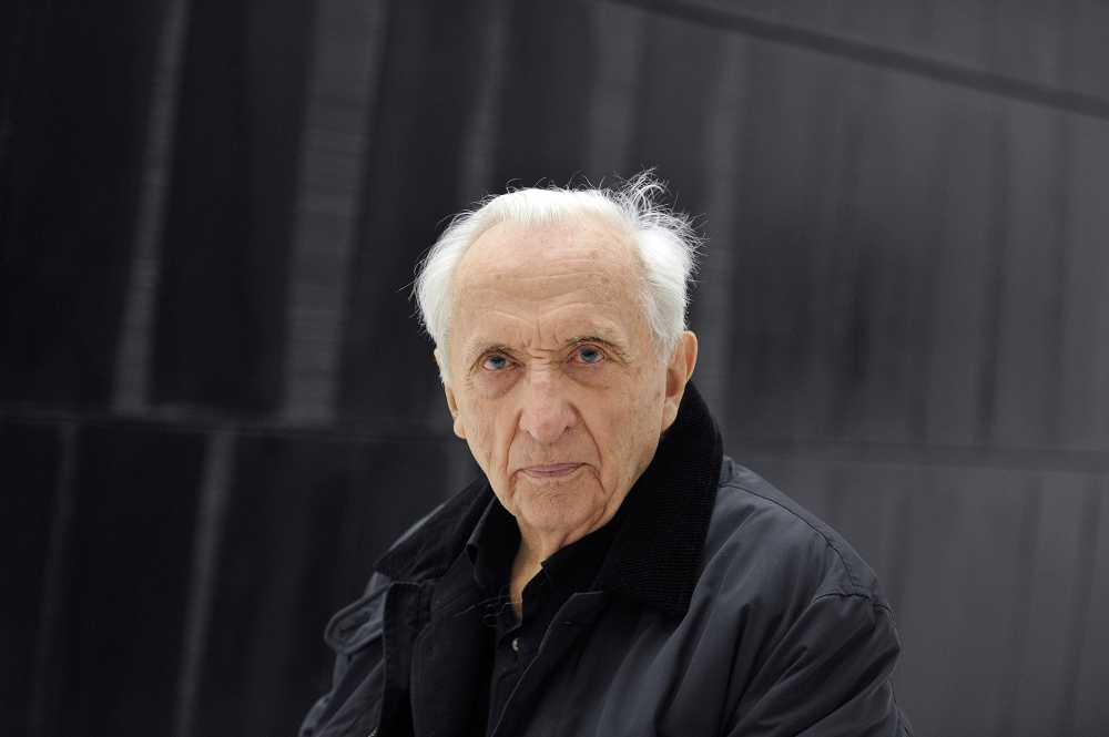 (FILES) In this file photo taken on May 28, 2014, French painter, engraver and sculptor, Pierre Soulages poses in front of one of his paintings at the museum of the « Outrenoir » master (« ultra-black »), in the French southwestern city of Rodez. AFP / Pa