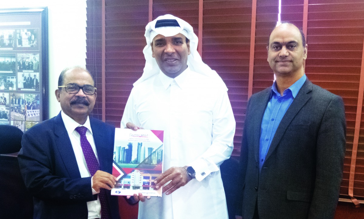 Jumbo Electronics’ Sajed Jassim Mohammed Sulaiman, Vice-Chairman & Managing Director, hands over the 2019 Business Strategy Document to C V Rappai, Director & CEO, as Rohit Pandit, COO, looks on.