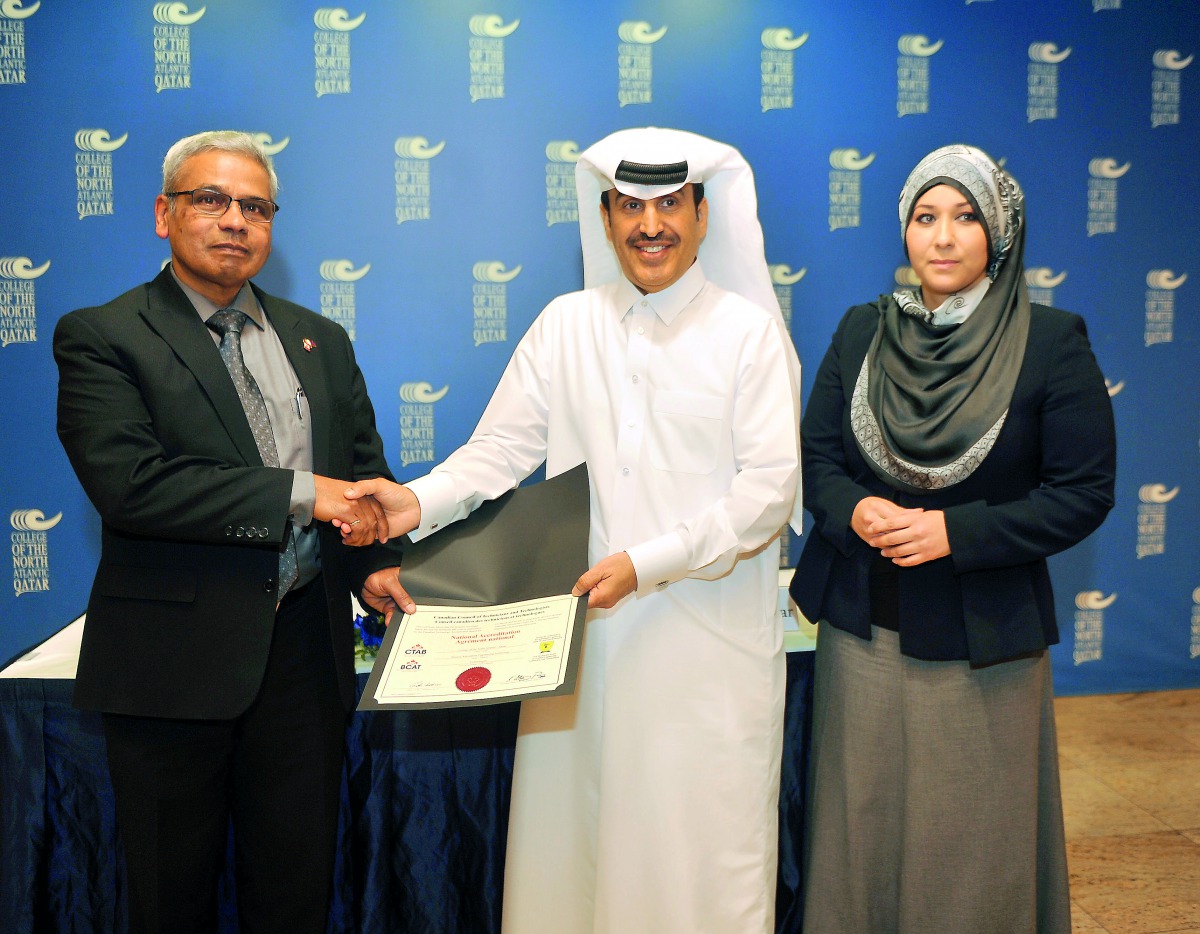 Dr Khalifa Nasser Al Khalifa (centre), CNA-Q President, receiving the  accreditations from Errol Persaud, P Eng, Education Consultant with CTAB, as Samah Gamar (right), Vice President-Academic CNA-Q, looks on at the CNAQ premises yesterday.  Pic: Abdul Ba