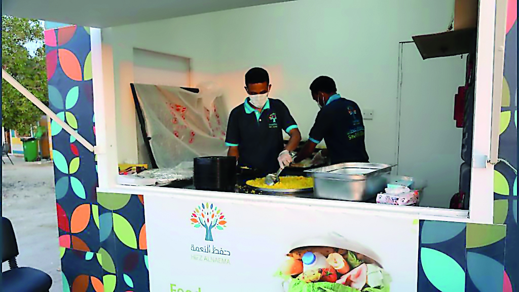 Members of Hifz Al Naema team repackaging surplus foods collected from the visitors of sealine.