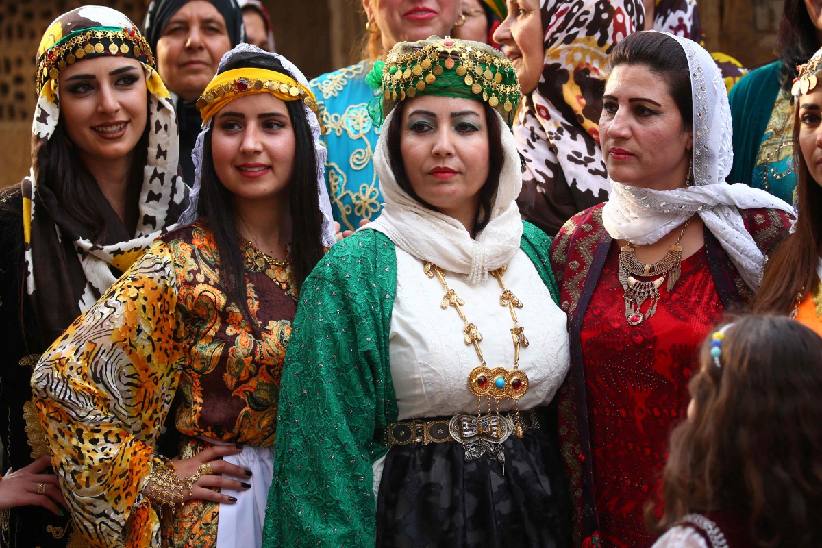 FILE PHOTO: Syrian-Kurdish women model traditional Kurdish attire during a fashion show in the northeastern Syrian city of Qamishli on March 10, 2017 which coincides with the Day of Kurdish Clothing. AFP/Delil Souleiman