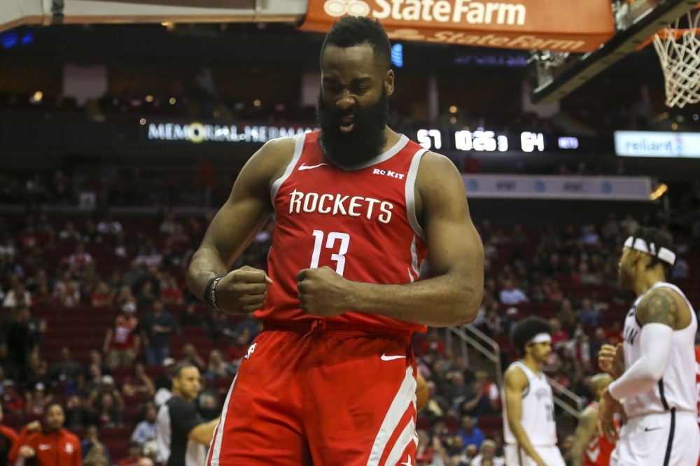 Houston Rockets guard James Harden (13) flexes after scoring on a layup during the third quarter against the Brooklyn Nets at Toyota Center. John Glaser