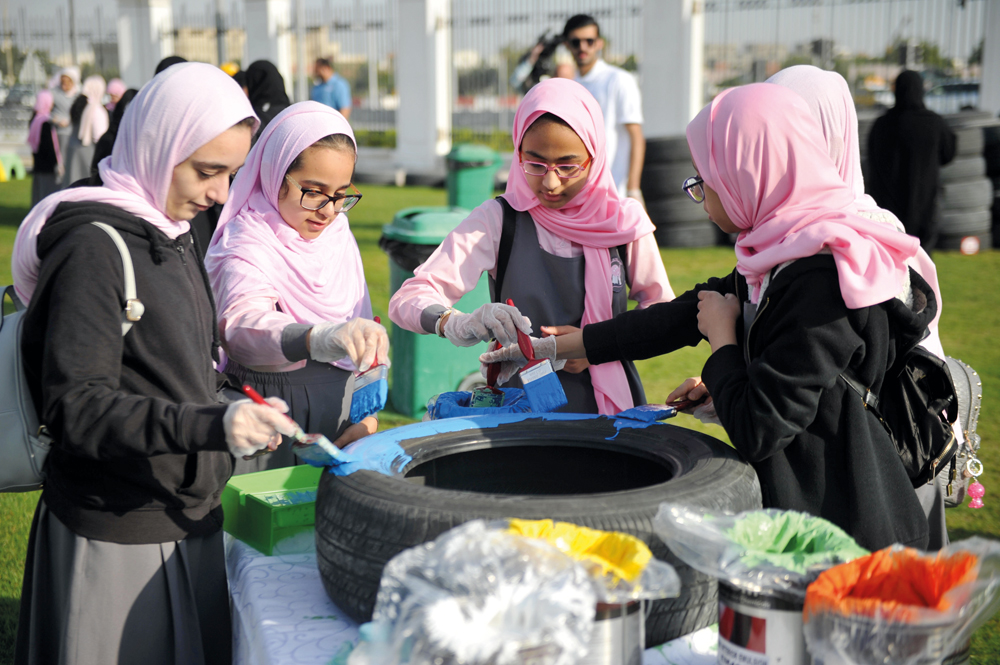 Schoolchildren taking part in different activities at Tarsheed Recycling Car tyres event held at Kahramaa Awareness Park yesterday. Pic: Abdul Basit / The Peninsula