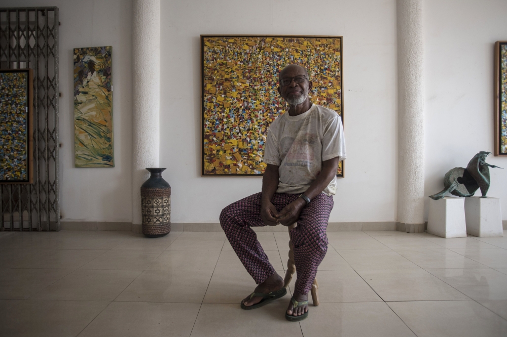 Ablade Glover, Ghanaian artist and educator, poses for a portrait in his showroom inside the Artist Alliance Gallery in Accra on December 11, 2018. AFP / CRISTINA ALDEHUELA 