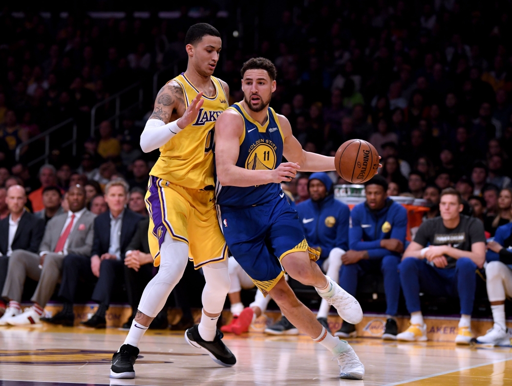 Klay Thompson #11 of the Golden State Warriors drives on Kyle Kuzma #0 of the Los Angeles Lakers during a 130-111 Warriors win at Staples Center on January 21, 2019 in Los Angeles, California. Harry How/Getty Images/AFP