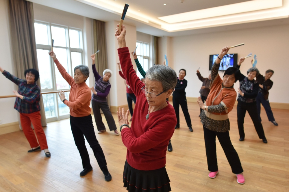 This photo taken on December 5, 2018, shows residents taking a dance class at the Yanyuan community for senior citizens, on the outskirts of Beijing. AFP / GREG BAKER 