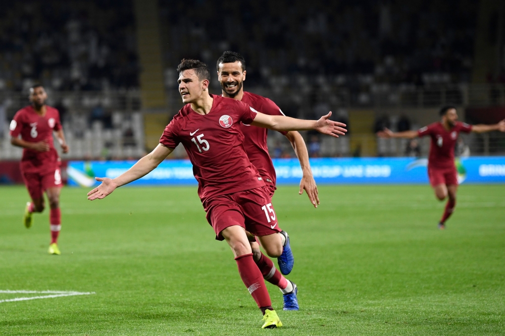 Qatar's defender Bassam Al Rawi (C) celebrates his goal during the 2019 AFC Asian Cup Round of 16 football match between Qatar and Iraq at the Al Nahyan Stadium in Abu Dhabi on January 22, 2019. / AFP / Khaled DESOUKI