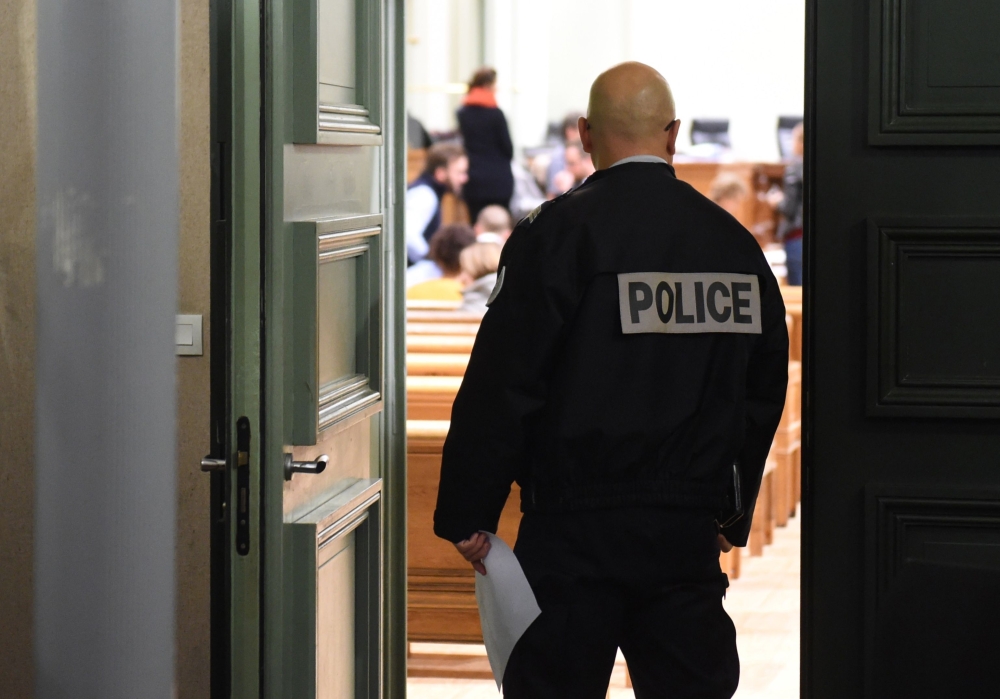 A police officer stands at the entrace of the courtroom in Bordeaux, southwestern France, on January 21, 2019 before the trial of Vincent Leroyer, a former hockey club coach, for sexual abuse and rape on a minor. AFP/Mehdi Fedouach 