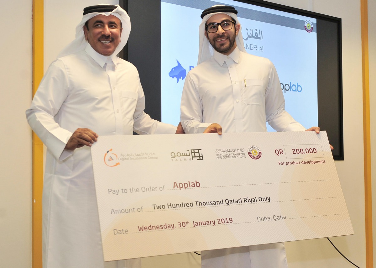 Minister of Transport and Communications (left) H E Jassim bin Saif Al Sulaiti, awarding a winner at the Digital Incubation Center, yesterday. Pic: Baher Amin / The Peninsula