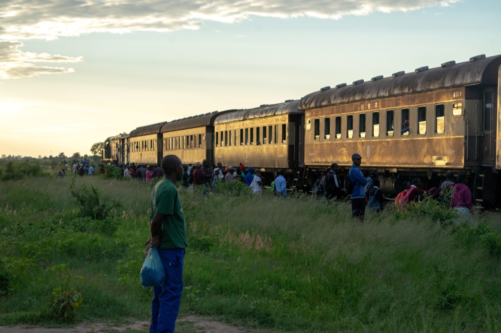 Commuters wait to board a train heading for the city on January 29, 2019, in Cowdray Park township, in Bulawayo, Zimbabwe. AFP / Zinyange Auntony