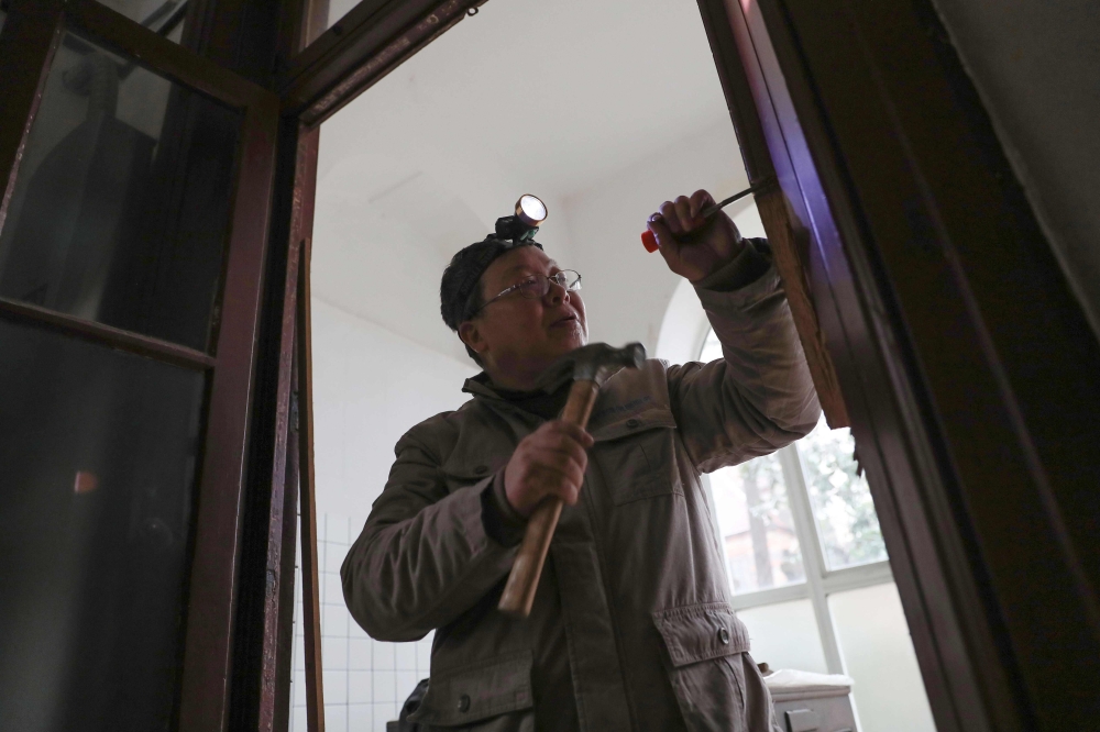 This file photo taken on January 31, 2019 shows carpenter Ma Jiale working in an old building in Shanghai. Peter Stebbings and Lan Lianchao / AFP / STR 