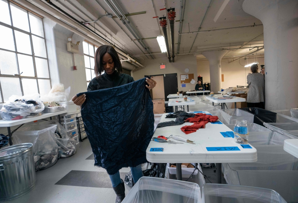 Fabscrap Operations Coordinator Sabina Montinar sorts fabric on February 1, 2019, at the company's warehouse in New York. AFP / Don Emmert 