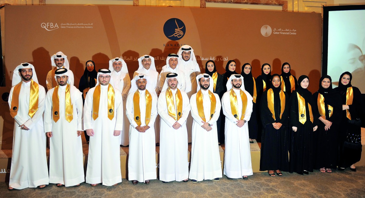 Minister of Finance H E Ali Shareef Al Emadi and Minister of Administrative Development, Labour and Social Affairs H E Yousef bin Mohammed Al Othman Fakhro with officials and graduates of ‘Kawader’ program. Pic: Abdul Basit / The Peninsula