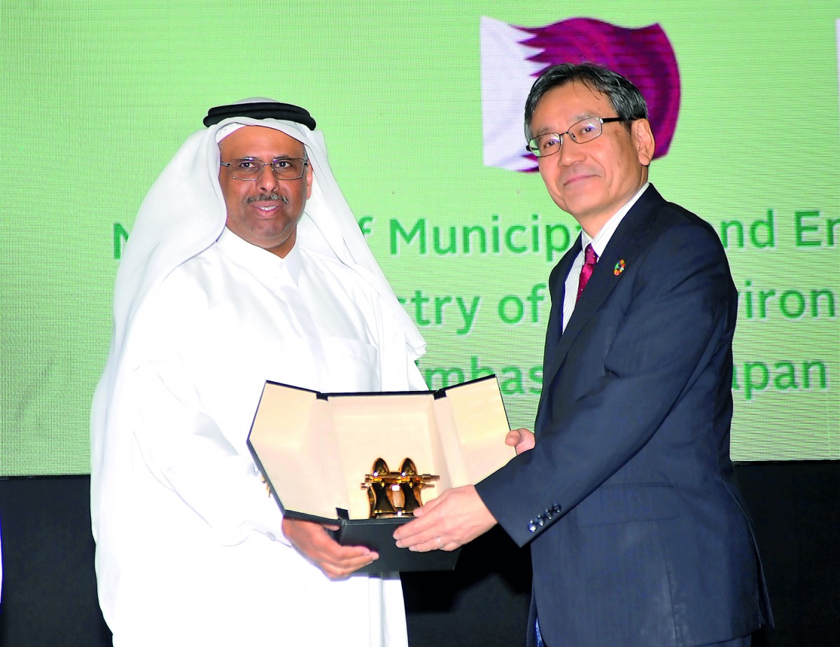 Sheikh Faleh Al Thani (left), MME Assistant Undersecretary for General Affairs, Ministry of Municipality and Environment, giving a memento to Yasuo Takahashi, Vice-Chairman, Global Enviroment Affairs, Ministry of Enviroment in Japan, on the opening sessio