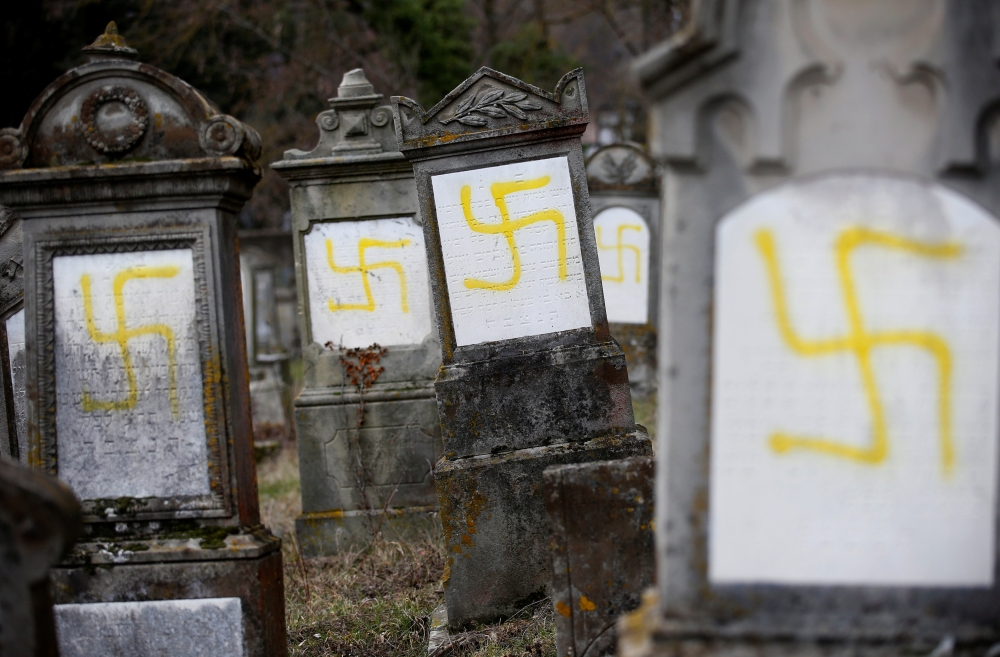 Graves that were desecrated with swastikas are seen at the Jewish cemetery in Quatzenheim near Strasbourg, France, February 19, 2019. Reuters/Vincent Kessler