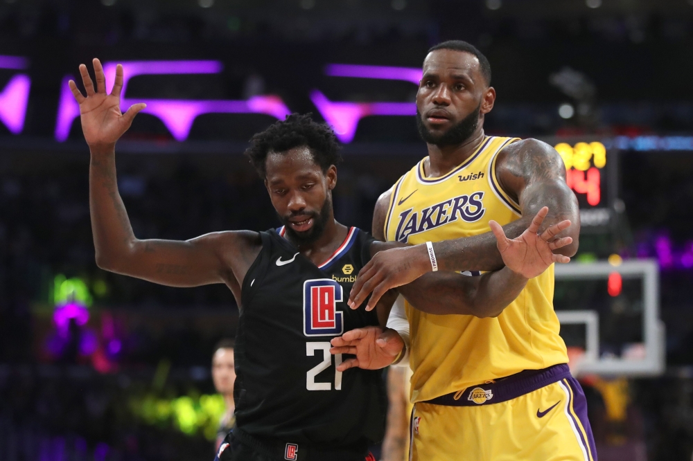 LeBron James #23 of the Los Angeles Lakers pushes Landry Shamet #20 of the Los Angeles Clippers during the second half of a game at Staples Center on March 04, 2019 in Los Angeles, California. 
