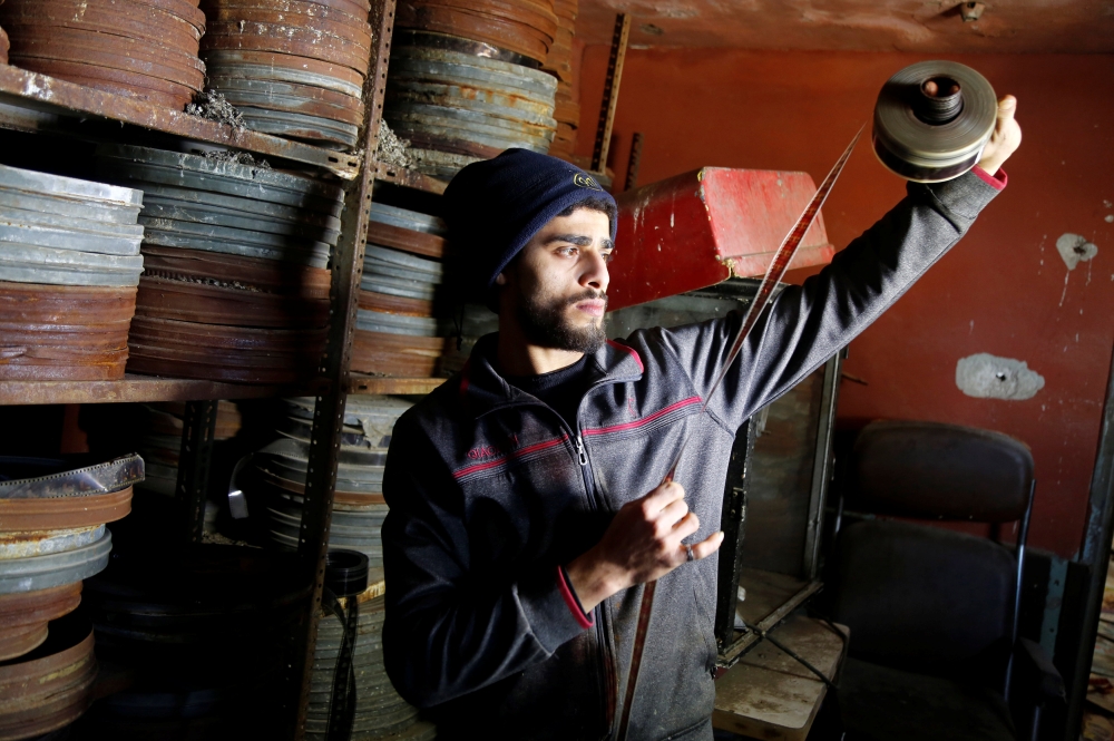 A Palestinian worker checks a film roll in a former cinema, in Tulkarm in the Israeli-occupied West Bank February 27, 2019. Picture taken February 27, 2019. REUTERS/Raneen Sawafta