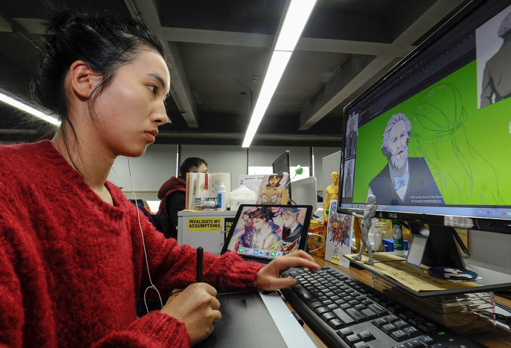 This photo taken on February 28, 2019 shows a staff member working on the online cartoon series 