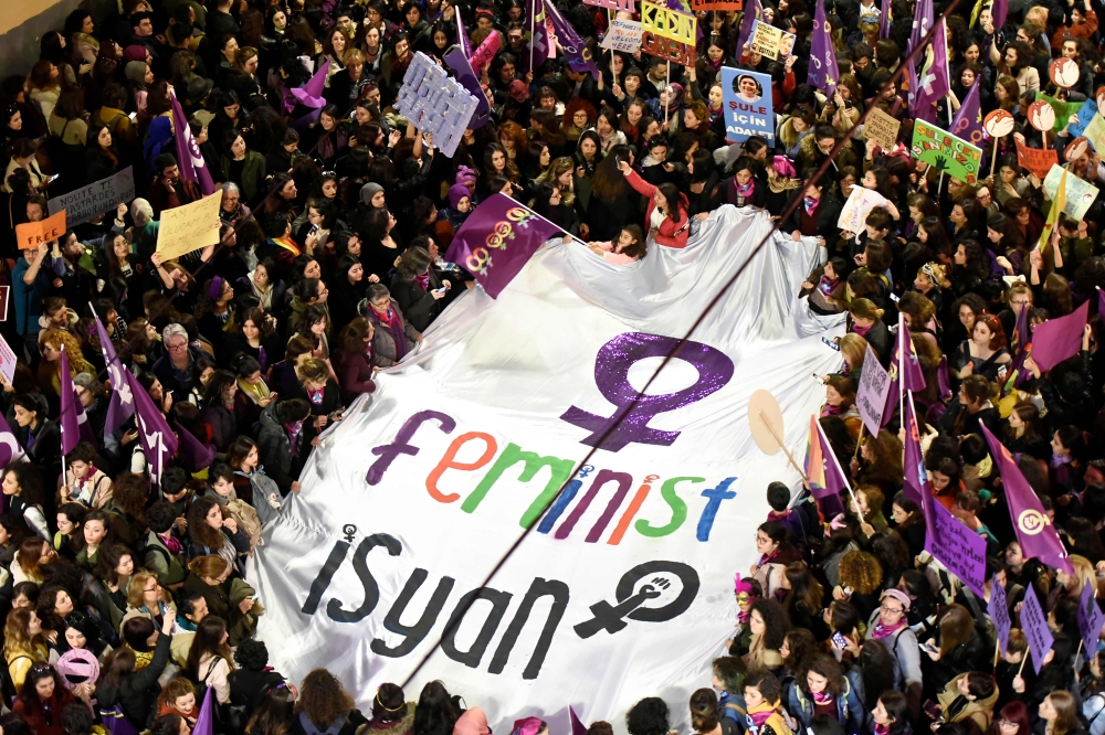 Demonstrators hold a banner and placards during a rally marking the International Women's Day on Istiklal avenue, in Istanbul on March 8, 2019.  AFP / Yasin Akgul
 