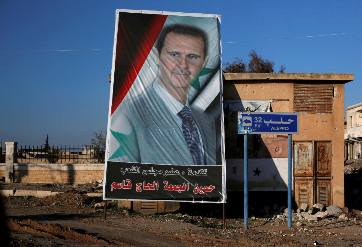 A picture of President Bashar al-Assad is seen in Ramouseh, a government controlled area of Aleppo,  Syria, December 8, 2016. Reuters/Omar Sanadiki