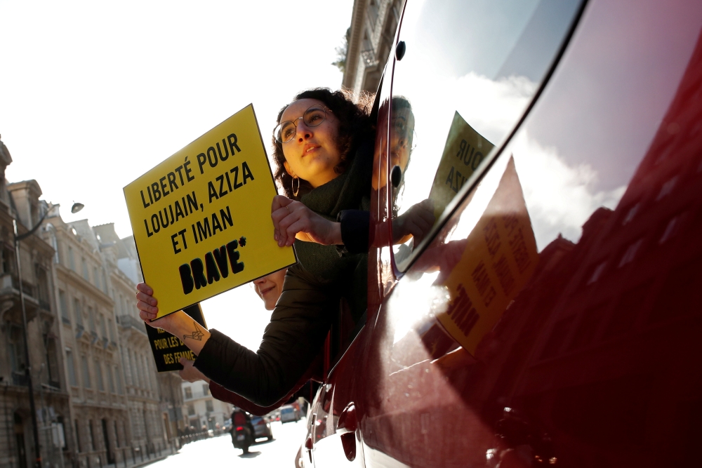 Demonstrators from Amnesty International hold placards outside the Saudi Arabian Embassy on International Women's day to urge Saudi authorities to release jailed women's rights activists Loujain al-Hathloul, Eman al-Nafjan and Aziza al-Yousef in Paris, Fr