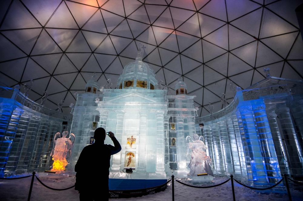 A tourist visits a Tatra Ice Temple at Hrebienok, High Tatras mountains resort in eastern Slovakia on February 27, 2019. AFP / Vladimir Simicek