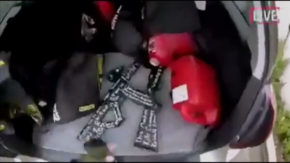 An image taken from a social media apparently taken by a gunman and posted online live as the attack unfolded, shows him retrieving weapons from the boot of his car in Christchurch, New Zealand, March 15, 2019