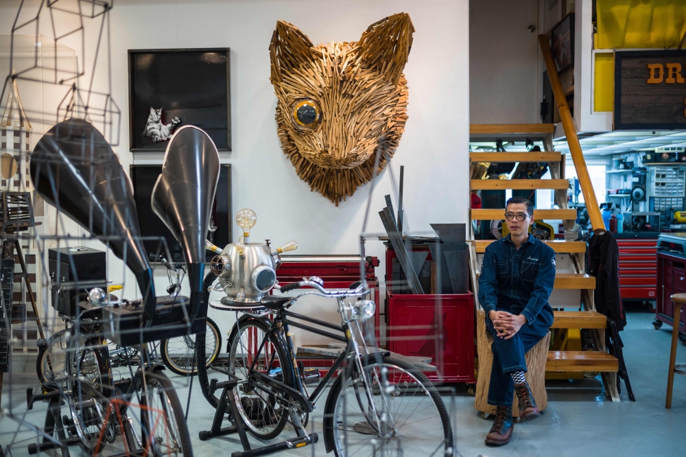 In this picture taken on December 6, 2018, local artist Kacey Wong poses at his studio in Hong Kong.  AFP/Anthony Wallace