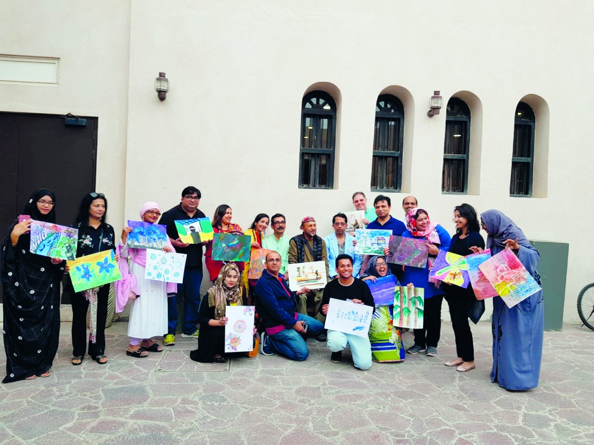 Participants with their paintings at an art workshop with the theme ‘Nature and Environment’ at Katara Art Studio.