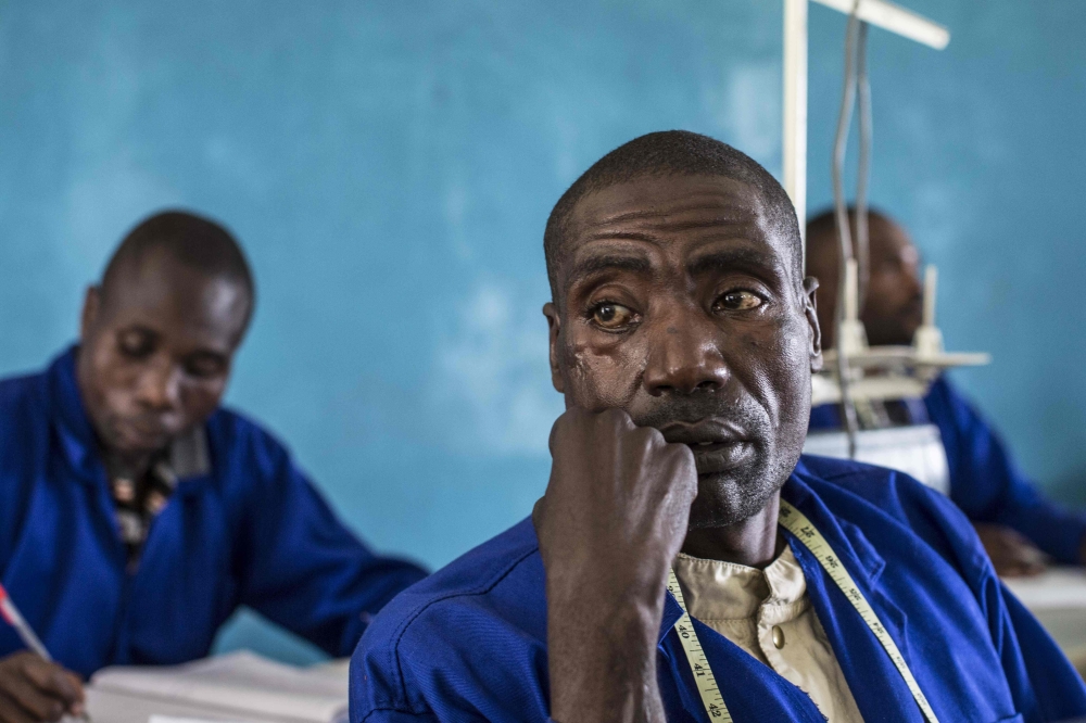 Serubanza Boniface, a former FLDR combattant, attends a class at a vocational training centre at the Reintegration and Demobilisation Centre in Mutobo, some 100 kilometres (60 miles) north-west of Kigali and beneath the Virunga mountains, on March 5, 2019