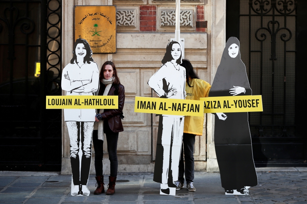 FILE PHOTO: Demonstrators from Amnesty International stage the protest on International Women's day to urge Saudi authorities to release jailed women's rights activists Loujain al-Hathloul, Eman al-Nafjan and Aziza al-Yousef outside the Saudi Arabian Emba