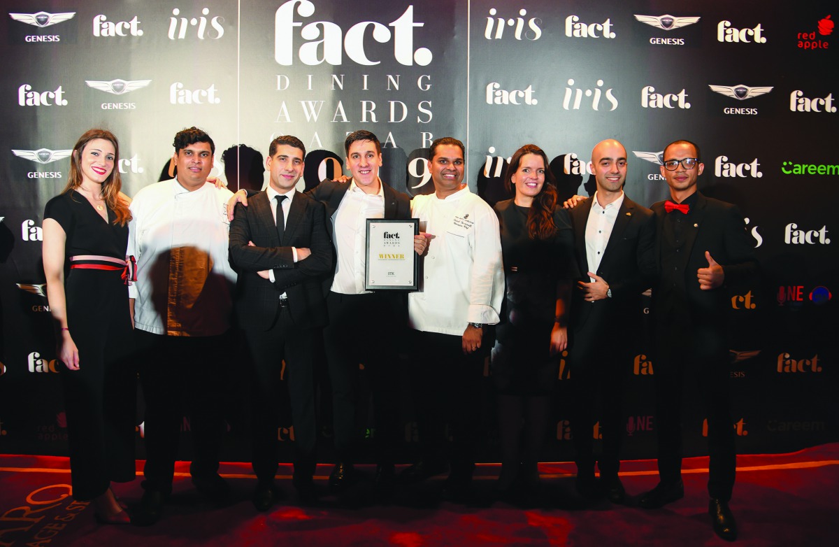 The employees of the STK Doha with the award.