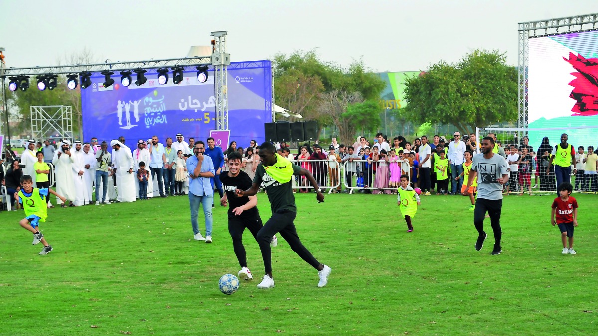 Qatar’s AFC Cup goal scoring hero, Almoez Ali, and Qatar National Football team members playing with children as part of a charity event organised by Qatar Charity to mark Arab Orphan Day at the Aspire Park in Doha yesterday.  Pic: Salim Matramkot / The P