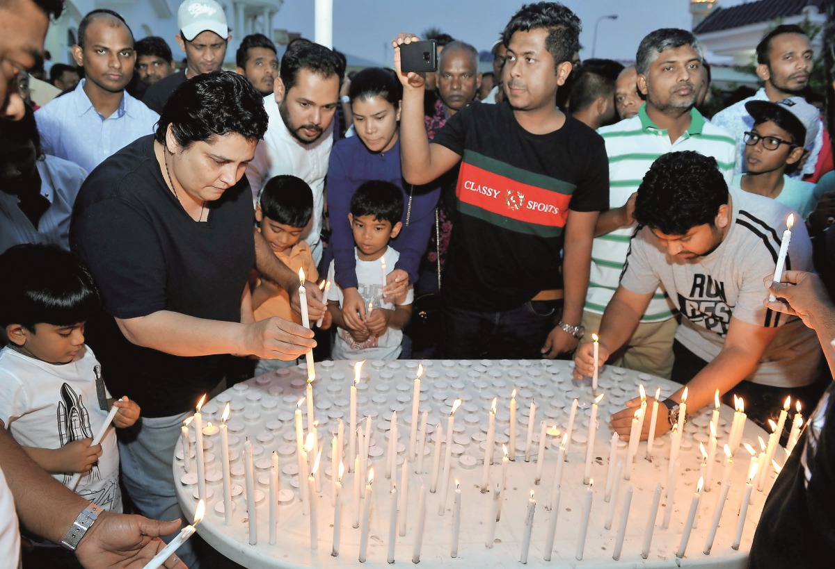 Sri Lankan residents light candles as they express solidarity with the victims of the attacks in their homeland during a function at the Sri Lankan Embassy in Doha yesterday. Pic: Salim Matramkot / The Peninsula 