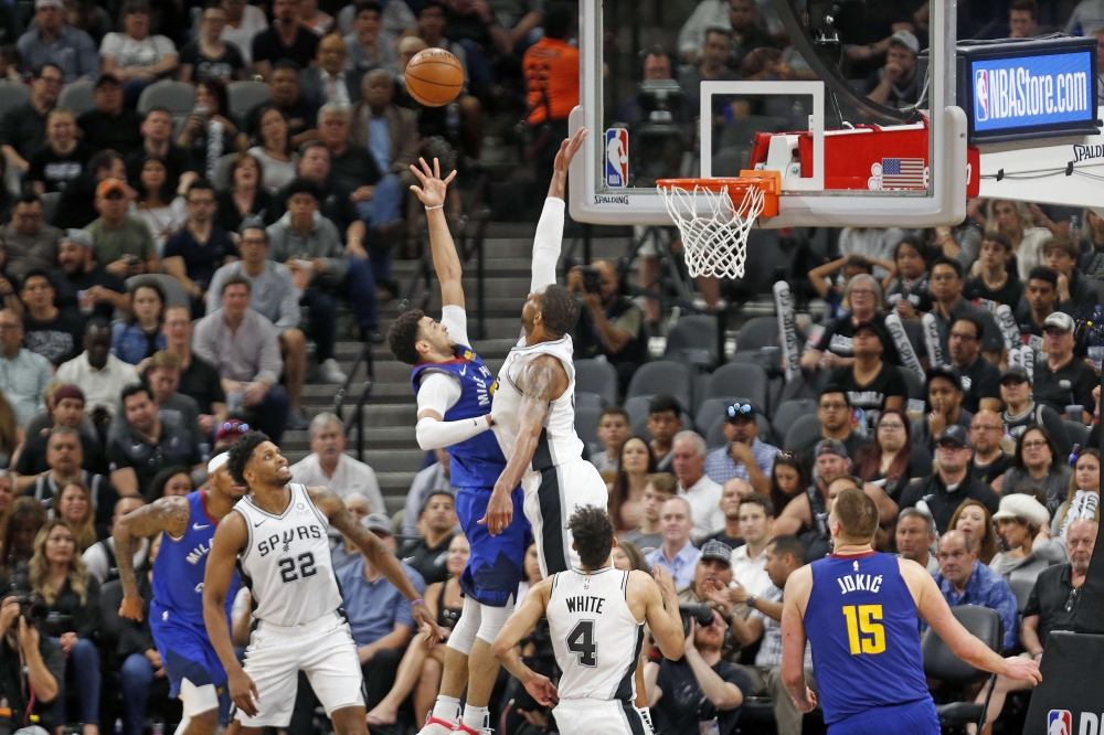 Jamal Murray #27 of the Denver Nuggets shoots over LaMarcus Aldridge #12 of the San Antonio Spurs during Game Six of the first round of the 2019 NBA Western Conference Playoffs at AT&T Center on April 25, 2019 in San Antonio, Texas.  Ronald Cortes/AFP 
