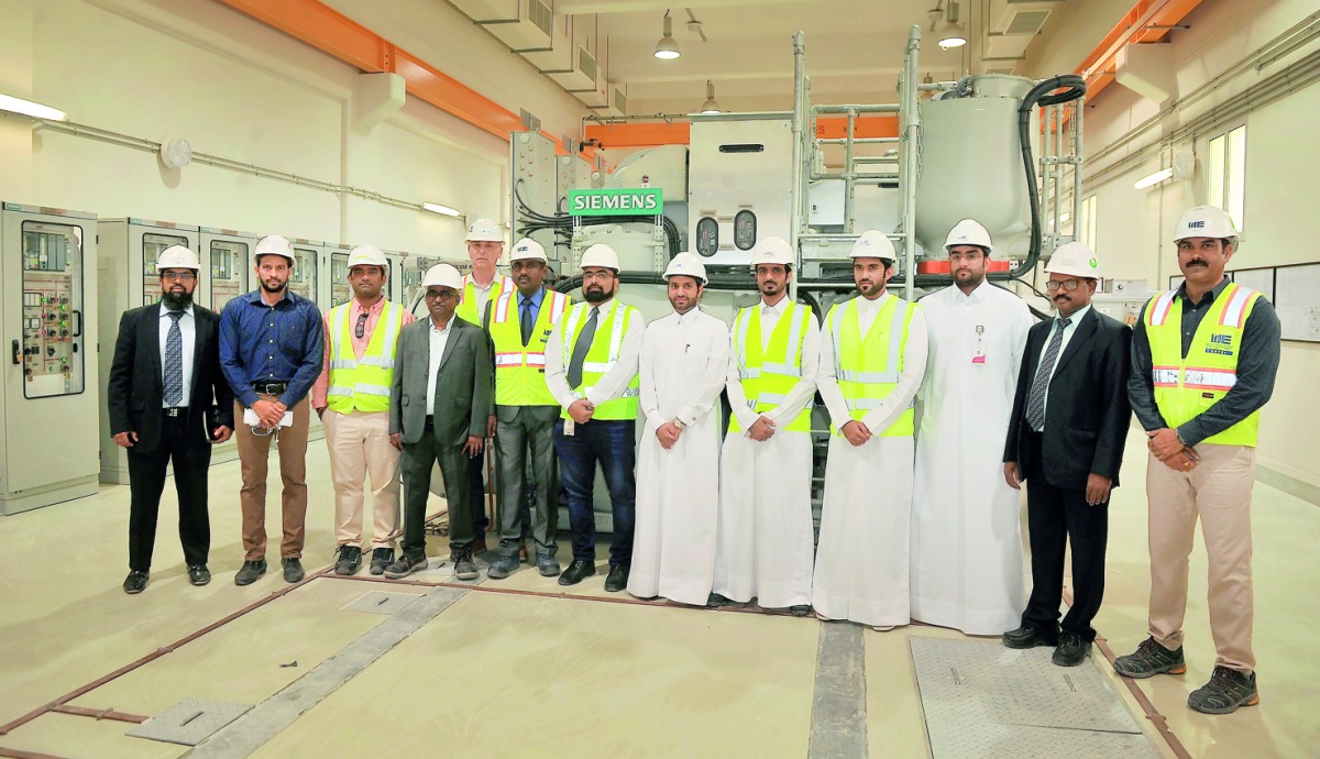 Rashid Al Rahimi (fifth right), the Head of the Engineering Works Section at the Electricity Projects Department of Kahramaa, with the project team, during the opening of Ras Abu Aboud station yesterday. Pic: Baher Amin / The Peninsula