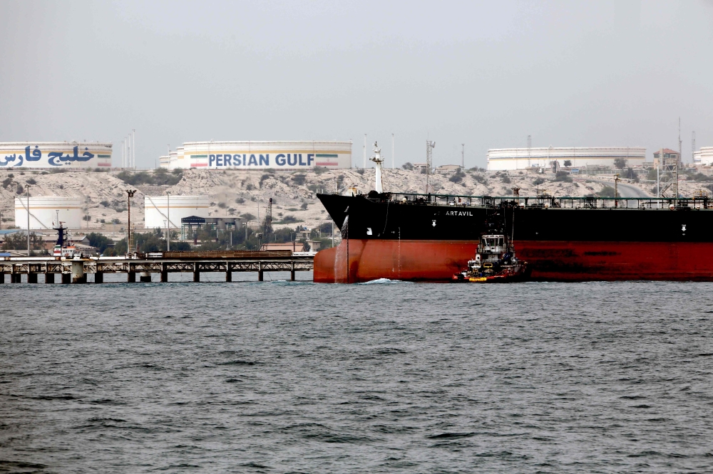 A picture taken on March 12, 2017 shows an Iranian tanker docking at the platform of the oil facility in the Khark Island on the shore of the Gulf. AFP/Atta Kenare