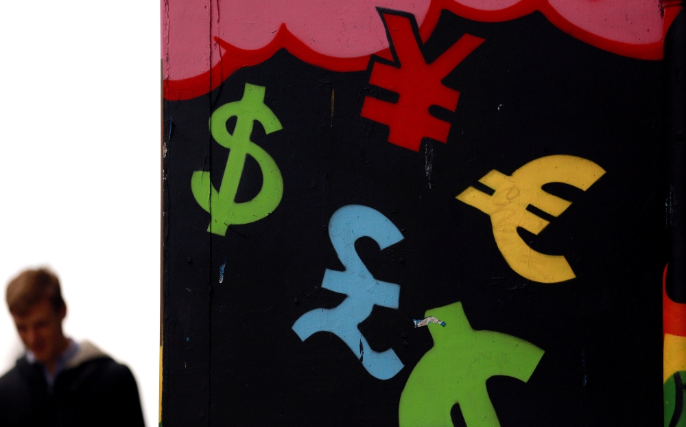 FILE PHOTO: Painted monetary symbols are seen on a wall in Dublin city centre October 22, 2014.  REUTERS/Cathal McNaughton