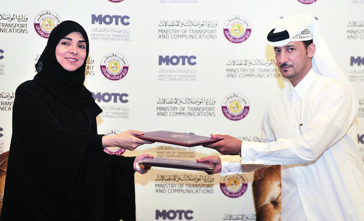 Ibtehaj Mohamed Al Ahmadani (left), Chairperson of Al Ahmadani Medical Centre, and Saleh bin Fattis Al Marri, Assistant Undersecretary for Maritime Transport Affairs at the Ministry of Transport and Communications, exchange documents after signing an MoC,