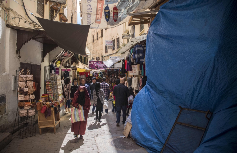 Tourists and locals walk in the 9th-century walled medina in the ancient Moroccan city of Fez on April 11, 2019. AFP / FADEL SENNA