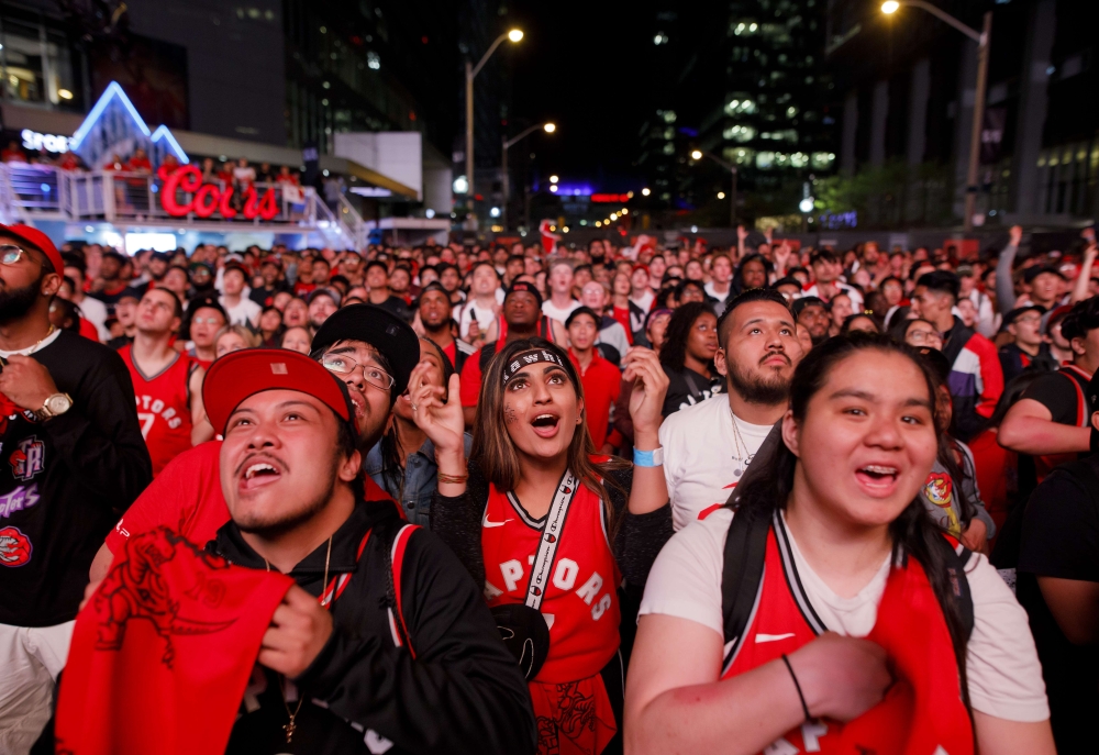 Toronto Raptors fans cheer as they gather to watch Game 4 of the NBA Finals series outside Scotiabank Arena at 'Jurassic Park', on June 7, 2019 in Toronto, Canada. Cole Burston/AFP