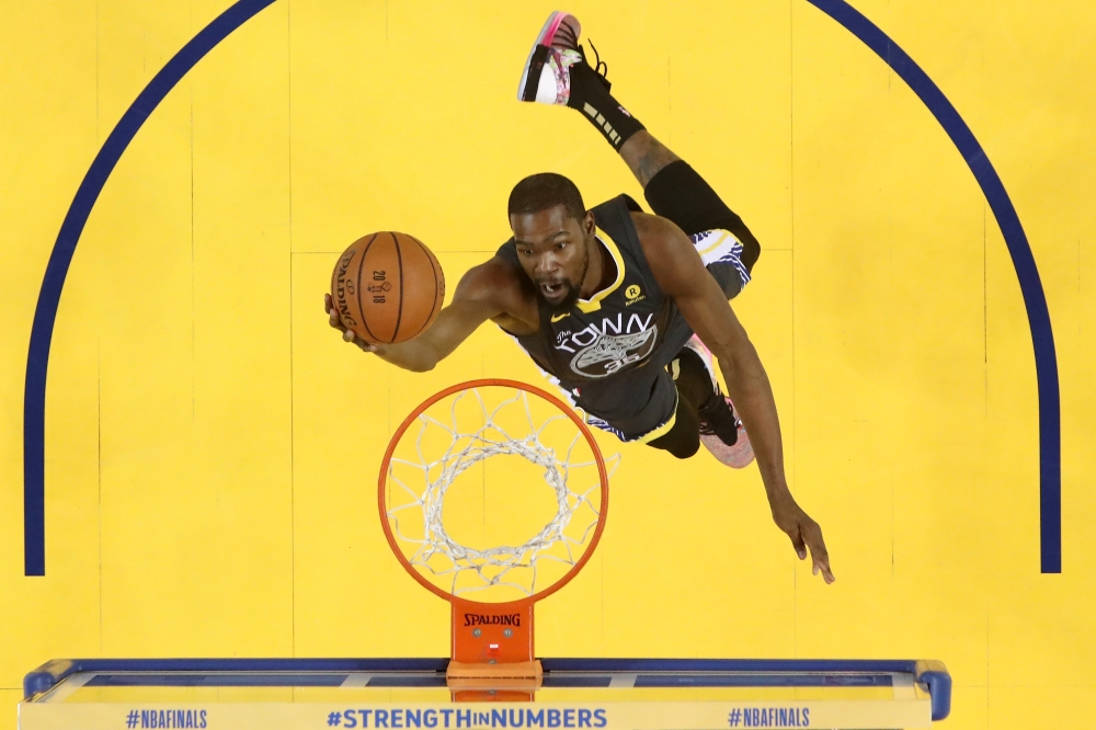 FILE PHOTO: Kevin Durant #35 of the Golden State Warriors attempts a layup against the Cleveland Cavaliers in Game 2 of the 2018 NBA Finals at ORACLE Arena in Oakland, California.
