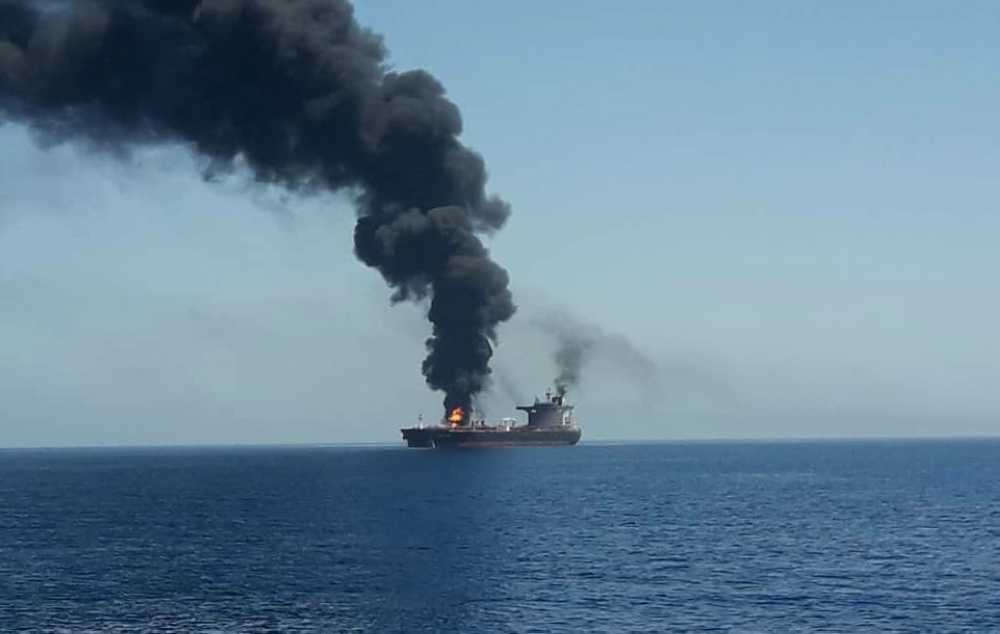 A picture obtained by AFP from Iranian State TV IRIB on June 13, 2019 reportedly shows fire and smoke billowing from a tanker said to have been attacked off the coast of Oman, at an undisclosed location. 